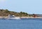 Motor yacht running along the blue sea along the shore. Adriatic sea of Mediterranean area. Dalmatian region of Croatian country.