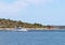 Motor yacht running along the blue sea along the shore. Adriatic sea of Mediterranean area. Dalmatian region of Croatian country.