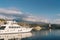 Motor yacht stands on the pier overlooking the lighthouse at the foot of the mountains