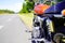 Motorbike alone aside route is vintage orange motorcycle parked in road in summer day