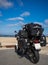 Motorbike at beach packed with camping equipment