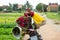 Motorbike with bouquets of colorful flowers on a rural road.