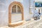 Motorbike in front of Authentic Window Arch in Santorini Island in Greece