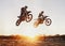 Motorbike, jump and adventure during race for competition as transportation with sunset. Men, motorcycle and action for
