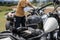 Motorbike parking and biker place helmet, Leather jacket and gloves on motorcycle. Young Traveller men ride motorcycle on highway