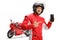 Motorbike racer in a jumpsuit showing a mobile phone