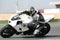 Motorbike on racetrack, leaning into sharp bend