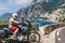 A motorbike traveler poses against the backdrop of an incredibly beautiful view of Positano, a city on the edge of cliffs, the sea