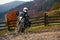 Motorbiker travelling in autumn mountains