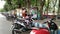 motorbikes and merchant carts lined up in the town square