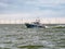 Motorboat cruising on IJsselmeer lake near Windpark Fryslan, Netherlands