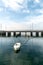 Motorboat with female captain passes from the lower to the upper Lake Zurich through the passage on the Seedamm bridge near Rappe