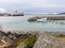 Motorboat and Hurtigruten cruise ship in Stokmarknes, Hadseloya, Vesteralen, Nordland, Norway