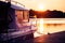 Motorboat near lake pier on sunset
