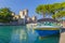 Motorboat at port Sirmione in front of castello Scaligero at lake Garda