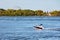 Motorboat sailing over the saint lawrence river with Saint Helen`s island and biosphere in the background  in Montreal, Quebec,