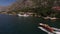 Motorboat sails along the mountainous coast with moored yachts