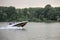 Motorboat speedboat with people, young friends, cruising on Sava river with a speed blur,