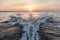 Motorboat wake pattern on sea at sunset