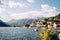 Motorboats are moored along the shore with ancient stone houses. Perast, Montenegro