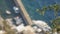 Motorboats moored at dock of small seaside town, Greek flag waving in wind