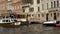 Motorboats and a water bus moored at the side of The Grand Canal, Venice, Italy