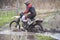 Motorcross rider racing in dirt track