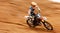 Motorcycle, balance and motion blur with a sports man on space in the desert for dirt biking. Bike, fitness and power