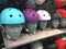 Motorcycle Colorful helmet Shop on the shelves. Multi-colored protective bike helmets in the shop. A mannequin wearing a