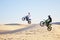 Motorcycle, desert and jump in air, speed and competition at outdoor race for performance, goal or off road. Motorbike