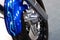 Motorcycle detail wheel. Shiny chrome wheel detail with a bright blue color