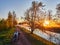 Motorcycle on a dirt road in a park at sunrise near flowering pear tree