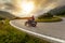 Motorcycle driver riding in Alpine landscape