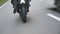 Motorcycle driving at asphalt route. Wheel of modern sport motorbike riding fast at highway. Motor bike racing on