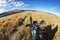 Motorcycle enduro traveler standing on high mountain road fish-eye view