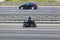 A motorcycle fast driving on motorway, side view