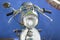 Motorcycle front detail with headlight, handlebars, mirrors, old vintage