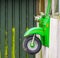 Motorcycle with headlights on a wall with windows, children toys and decorations