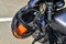 Motorcycle helmet hangs on handlebars of motorcycle. Protection when riding bike. Road safety for motorcyclists. black and orange