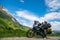 Motorcycle lady standing with adventure motorbike on the top mountain, enduro, off road, beautiful view, danger road in mountains