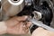 Motorcycle mechanic use a vernier to check and adjusting chain tension ,maintenance and service and repair concept , selective