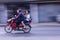 Motorcycle panning in road, Asia