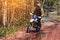 motorcycle racer on an enduro sports motorcycle rides on a muddy road in the forest in an off-road race