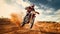 A motorcycle racer rides through the desert and over rough roads at high speeds