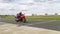 A motorcycle racer takes a practice run on a sports track
