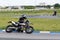 A motorcycle racer takes a practice run on a sports track