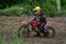 Motorcycle racers In rainy weather and a muddy track