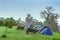 Motorcycle with rain. Camping activity in rain-filled holiday. Tent on campsite by the hill in rainy day. Mountain camp in forest