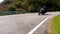 Motorcycle ridding in himalayan mountain twisty road at morning from low angle