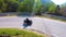 Motorcycle ridding in himalayan mountain twisty road at morning from low angle